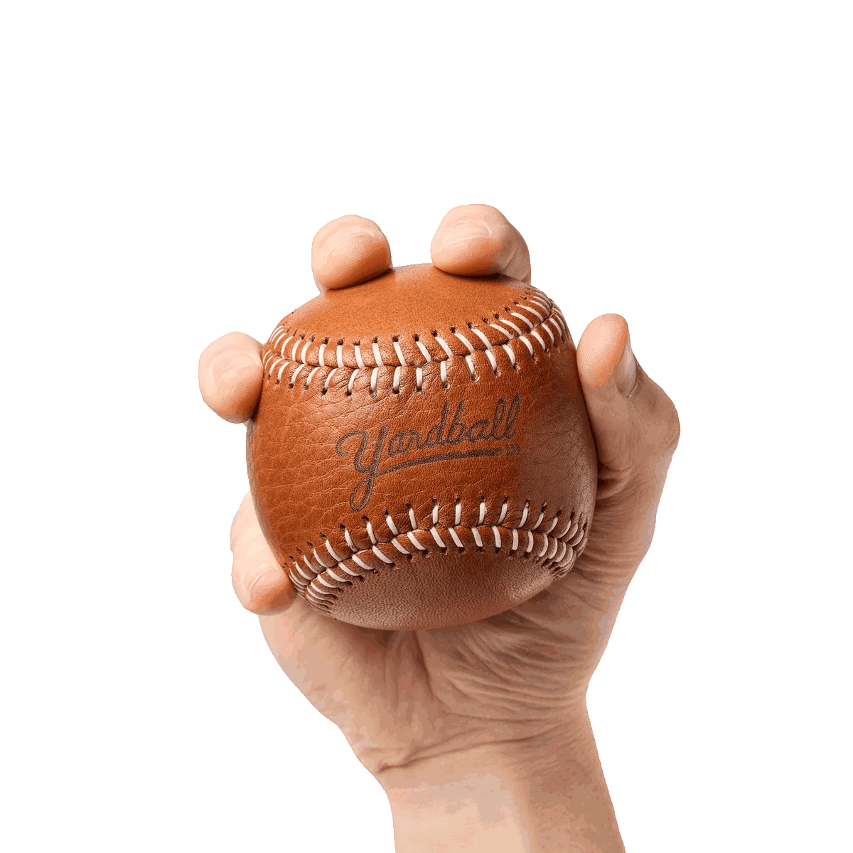 A hand squeezing a Glove Tan Yardball, the ball giving under the fingers